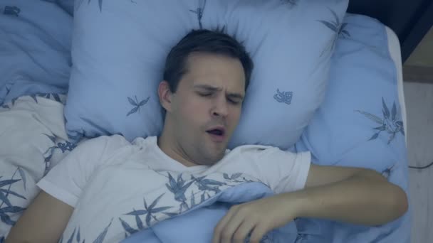 top view. closeup. young man in bed suffering insomnia - Metraje, vídeo