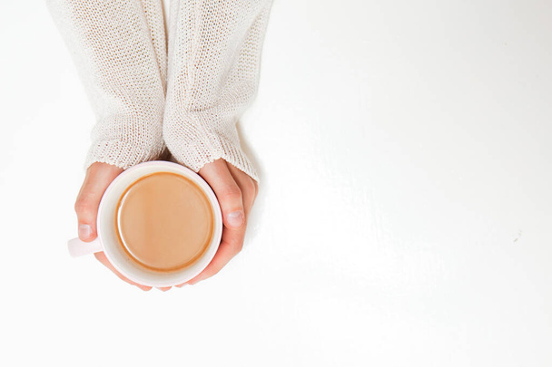 Female hands holding cups of coffee on white table background - Foto, Imagem