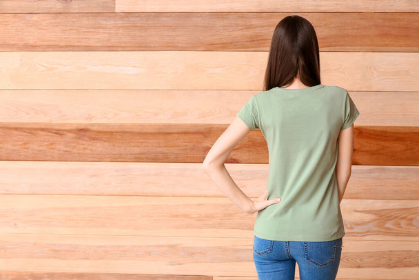 Woman in stylish t-shirt on wooden background - Photo, Image