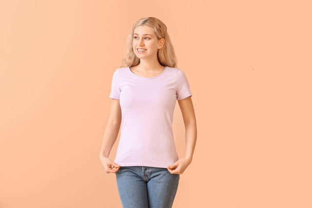 Woman in stylish t-shirt on color background - Φωτογραφία, εικόνα