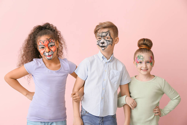 Funny little children with face painting on color background - Photo, Image