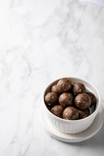energy balls of oatmeal, nuts and dried fruits on a light gray background. Healthy eating . Place for text. - Foto, Bild