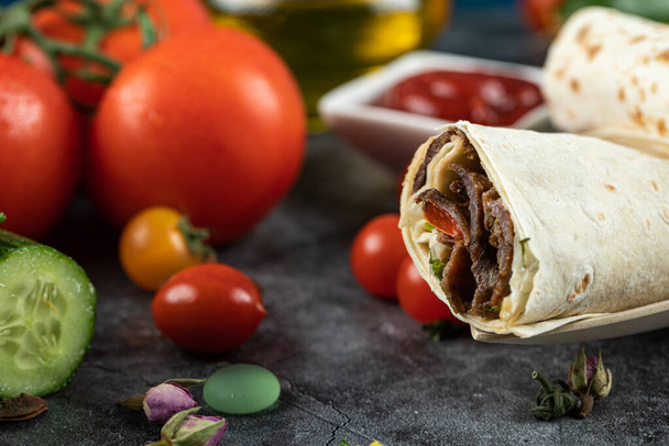Meat shaurma rolls in lavash with colorful cherry tomatoes - Photo, Image