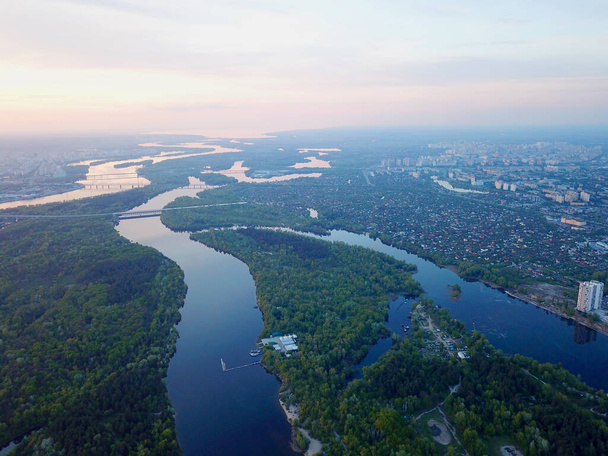 Sunset over the Dnieper River in Kyiv. Aerial drone view - Photo, Image