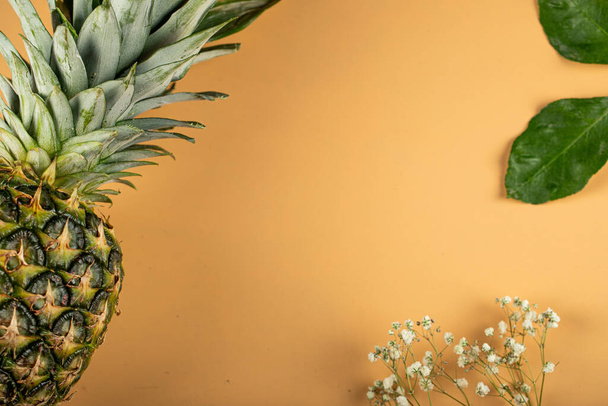 A fresh pineapple framing on orange color background - Photo, Image