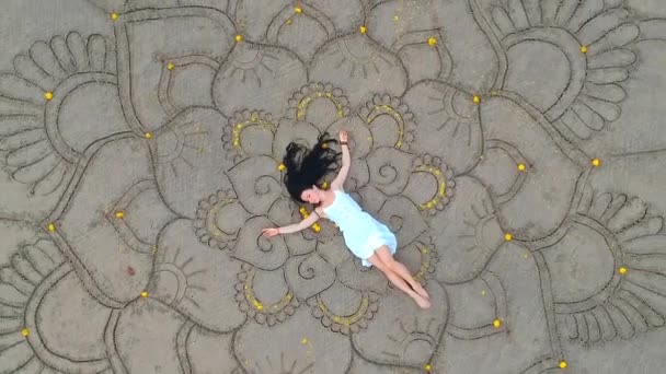 Frau zeichnet das große Mandala am Sand und tanzt im leeren Strandblick oben vom Drohnen-Quadrocopter. Konzept der Weiblichkeit und Unabhängigkeit - Filmmaterial, Video