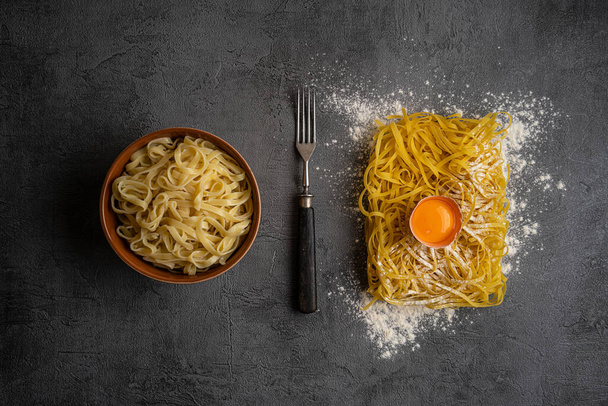 Still life with raw homemade pasta and boiled pasta and ingredients for pasta - Foto, immagini