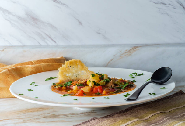 Сердечный итальянский минестронский суп с колбасой и чипсами из пармезана - Фото, изображение