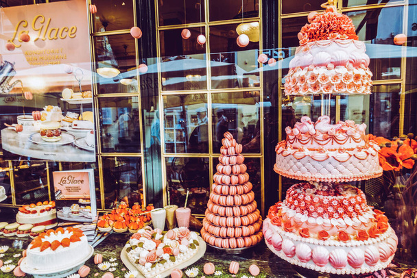 Linda vitrine com bolos em uma rua pitoresca
 - Foto, Imagem