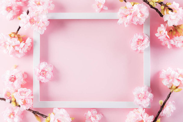 Happy Mother's Day, Women's Day or Valentine's Day greeting concept. Pastel Pink Colours Background with picture frame and blossom flowers flat lay patterns. - Foto, Imagen