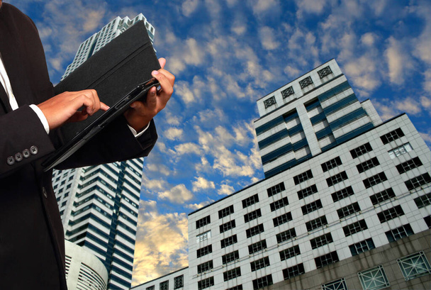 Onherkenbare zakenman poseren op moderne stad achtergrond - Foto, afbeelding