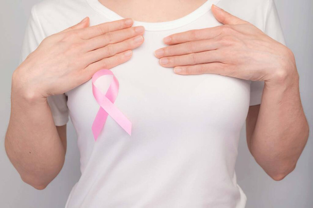 World Breast Cancer Day Concept,health care - woman wore white t-shirt,Pink ribbon for breast cancer awareness, symbolic bow color raising awareness on people living with women's breast tumor illness - Photo, image