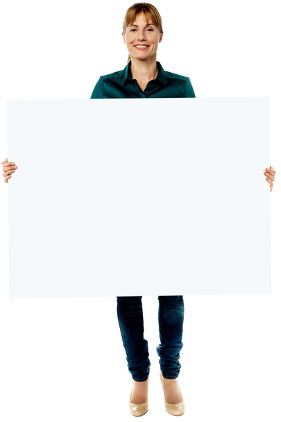 Attractive woman holding blank ad board - Zdjęcie, obraz