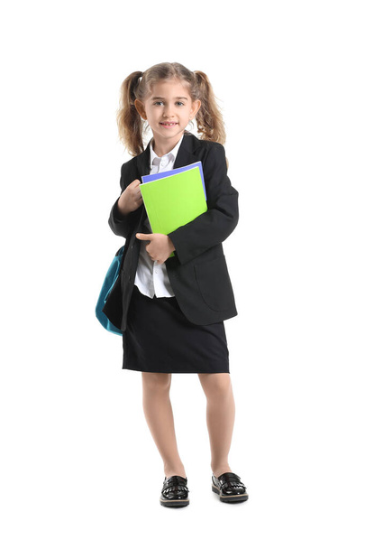 Cute little schoolgirl on white background - Фото, изображение