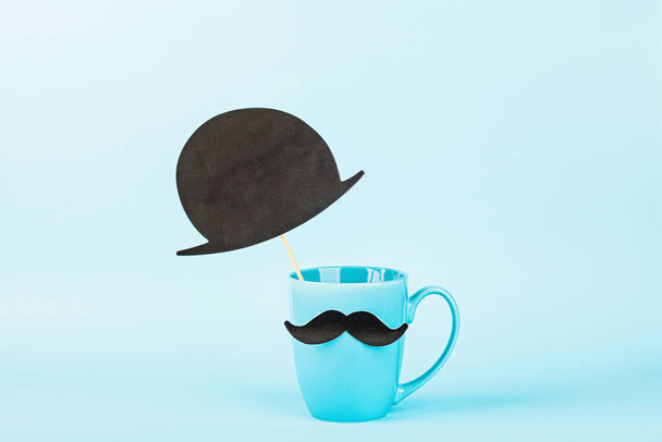 Happy Fathers Day background. gift box, coffee cup with funny moustache on blue table. mockup, template, greeting card, copy space. - Фото, зображення