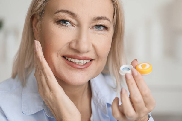 Mature woman with contact lenses at home - Photo, Image