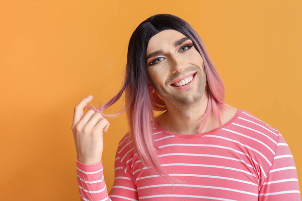 Portrait of young transgender woman on color background - Zdjęcie, obraz