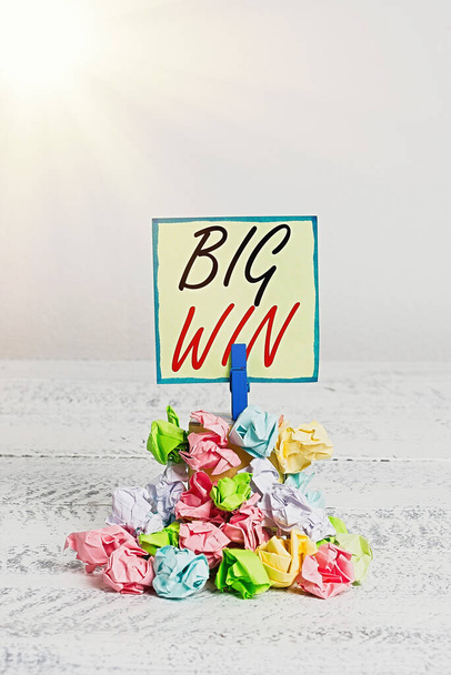 Conceptual hand writing showing Big Win. Business photo showcasing having won an important prize Money won by success in a game Reminder pile colored crumpled paper clothespin wooden space. - Photo, Image