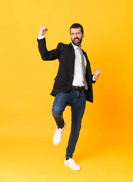 Full-length shot of business man over isolated yellow background - Foto, imagen