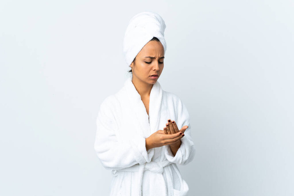 Young woman in bathrobe over isolated white background suffering from pain in hands - Fotoğraf, Görsel