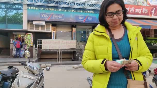 woman counting money on yes bank background - 映像、動画