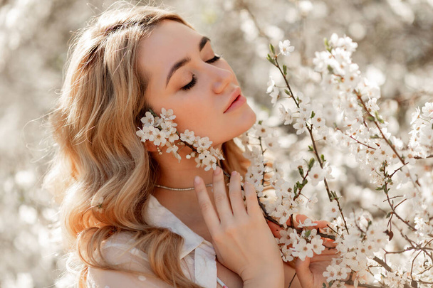 Beautiful natural woman during spring blossom time - Photo, Image
