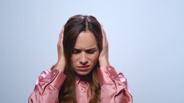 Exhausted businesswoman holding hands on head in studio. Woman having headache - Materiaali, video