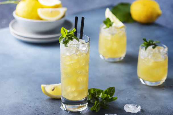 Fresh summer cocktail with lemons, mint and ice, selective focus image - Фото, изображение
