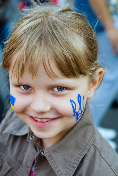Ukrainian trident on the cheek of small girl - Photo, Image