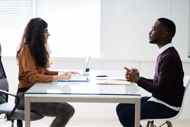 Female Manager Interviewing A Young Male Applicant In Office - Photo, image