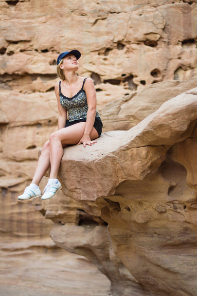 Chica sentada en una roca. - Foto, imagen