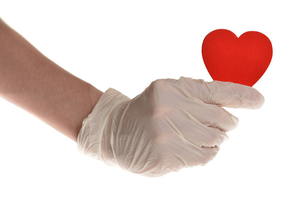 Серця в руці з гумовими рукавичками ізольовані на білому
 - Фото, зображення