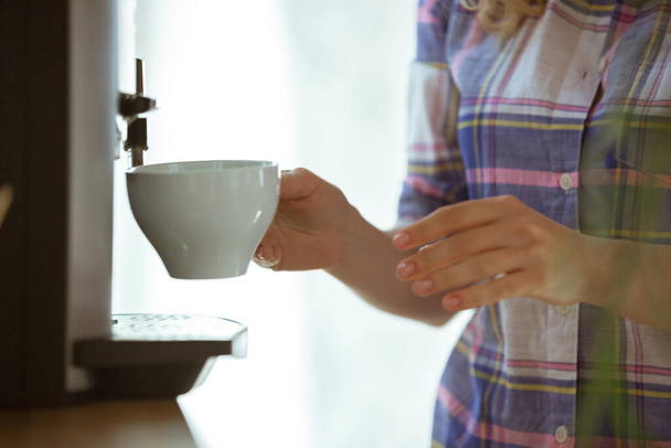 Close up of female hands making coffee on coffee-machine at home or cafe - Fotoğraf, Görsel