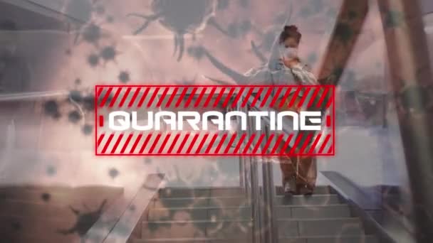 Animation of the word Quarantine written in white letters with red striped rectangle over macro coronavirus Covid-19 cells spreading over a woman walking down stairs wearing a face mask at a railway station.  - Кадри, відео