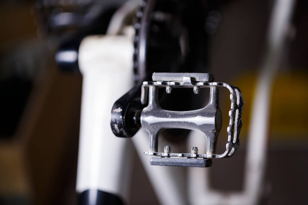 Black metal pedal on a bike with hard light. Bike accessories - Photo, Image