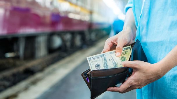Young woman backpacker traveler hands holding wallet dollar currency money plan to saving spend budget for holiday buy cheap discount deals travel promotion trip after coronavirus empty tourist crisis - Photo, Image