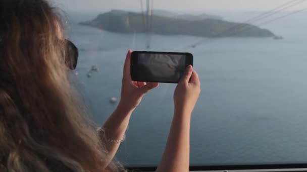Woman capturing sea scenery from cable car in Phu Quoc, Vietnam - Footage, Video