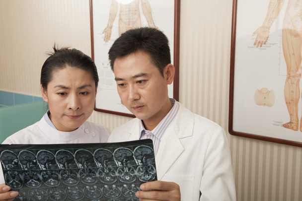 Doctor and Nurse Examine an X-Ray - Photo, Image