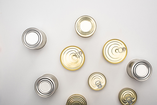 top view of cans with canned food on white background, food donation concept - 写真・画像
