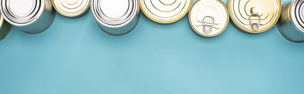 top view of cans on blue background with copy space, food donation concept - Photo, Image