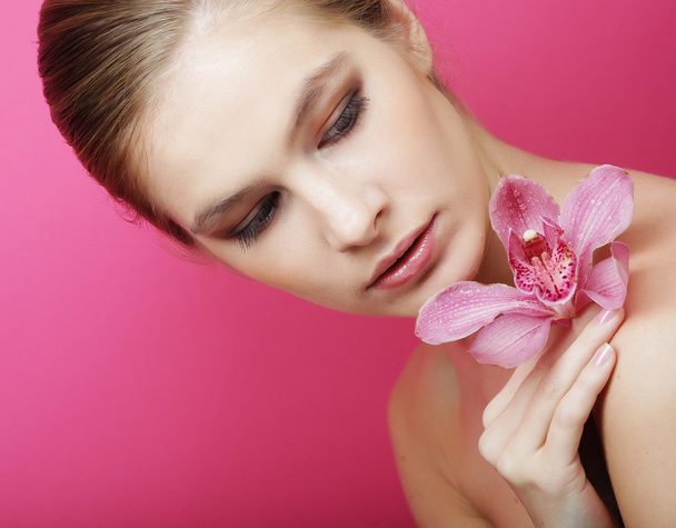Beautiful happy woman with orchid flower - Foto, imagen