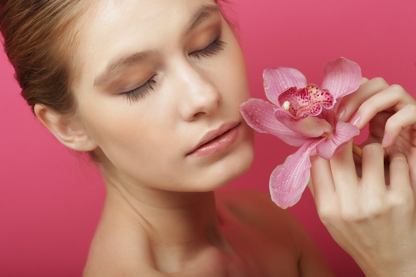 Beautiful happy woman with orchid flower - Photo, Image