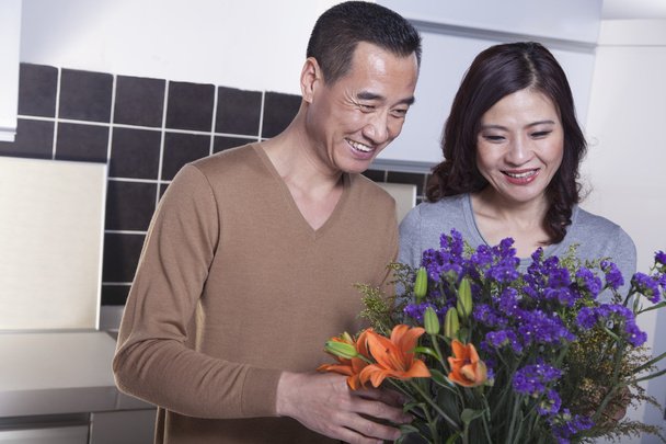 ώριμο ζευγάρι κοιτάζοντας λουλούδια - Φωτογραφία, εικόνα