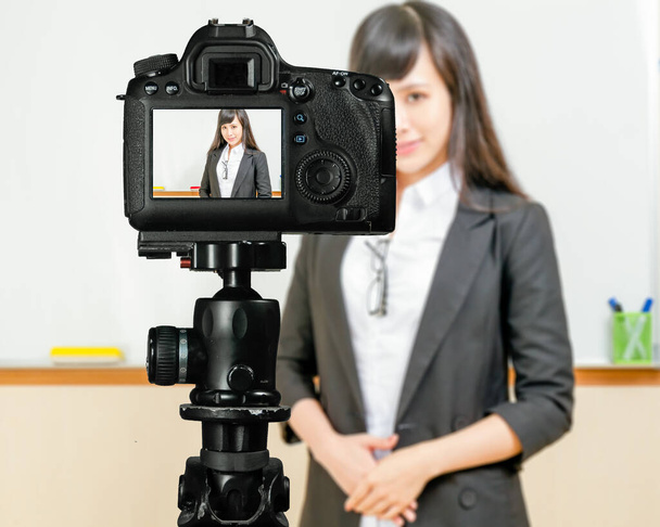 Asian American teacher streaming class with camera for students at home - Foto, afbeelding