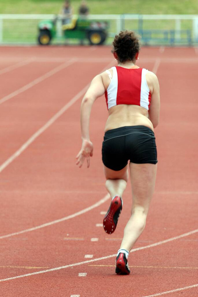 Woman at the start of an athletics race - Photo, Image