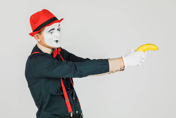 Clown with red suspenders and red hat on white background. - Photo, Image