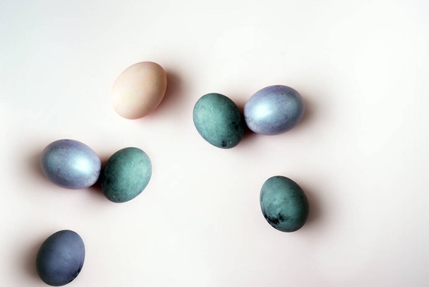 painted Egg shaped and space for text on pink background, flat lay. Easter celebration concept - 写真・画像