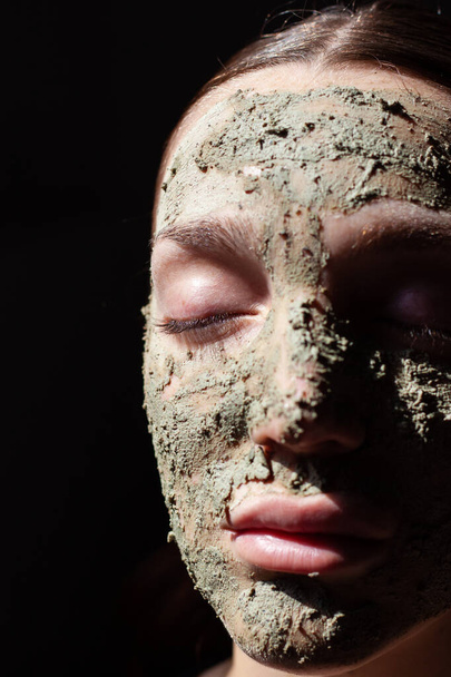 Κοντινό πλάνο της γυναίκας με οργανική καλλυντική μάσκα (scrub) με φυσικά εκχυλίσματα στο πρόσωπό της - Φωτογραφία, εικόνα