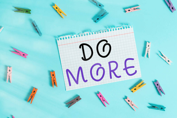 Writing note showing Do More. Business photo showcasing act of being productive or creative with less money or resources Colored clothespin rectangle shaped paper blue background. - Photo, Image