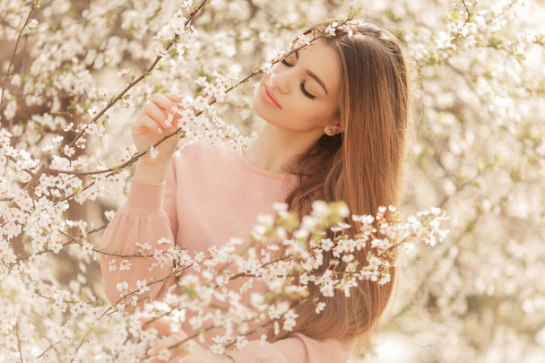 Beautiful natural woman during spring blossom time. - Photo, Image
